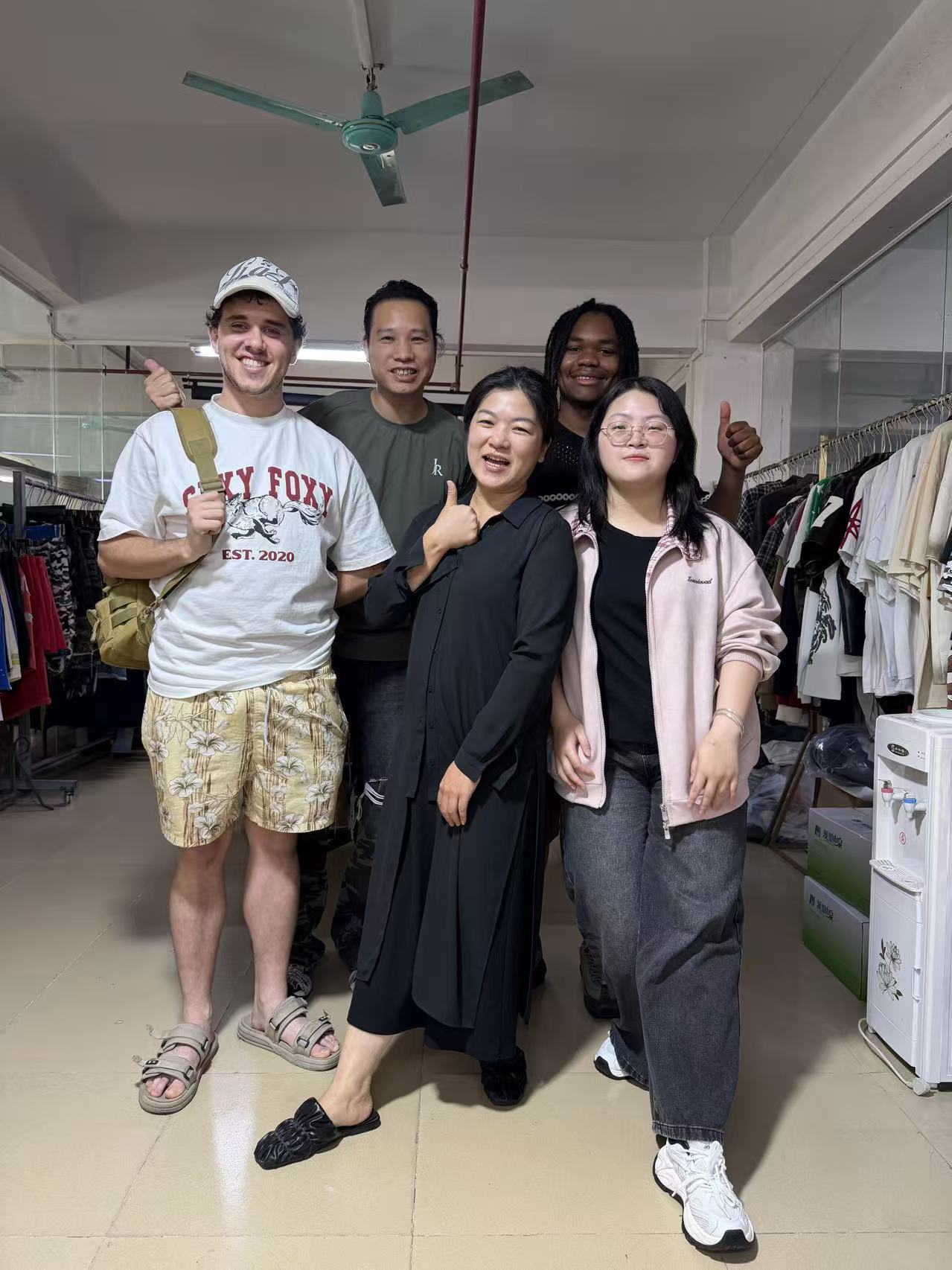 Clients touring custom clothing manufacturer JiuvelWear workshop