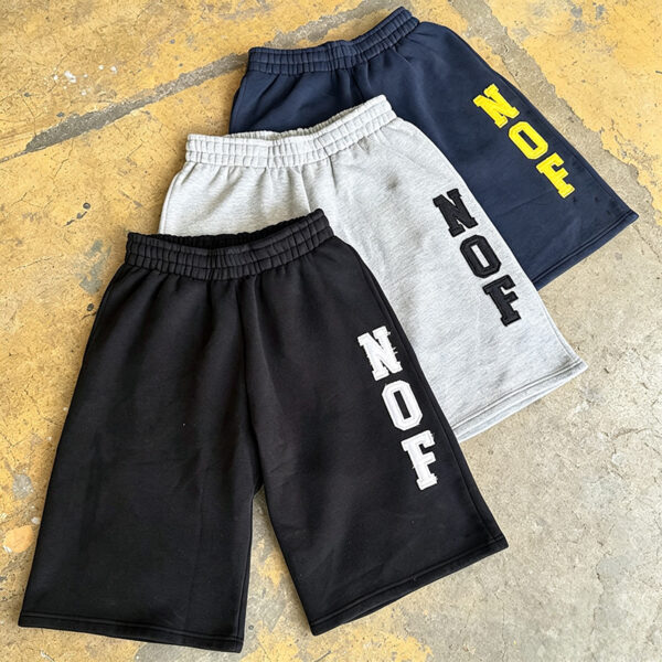 IMG_20260727_173419 Model wearing embroidered 3/4 fleece capri shorts men